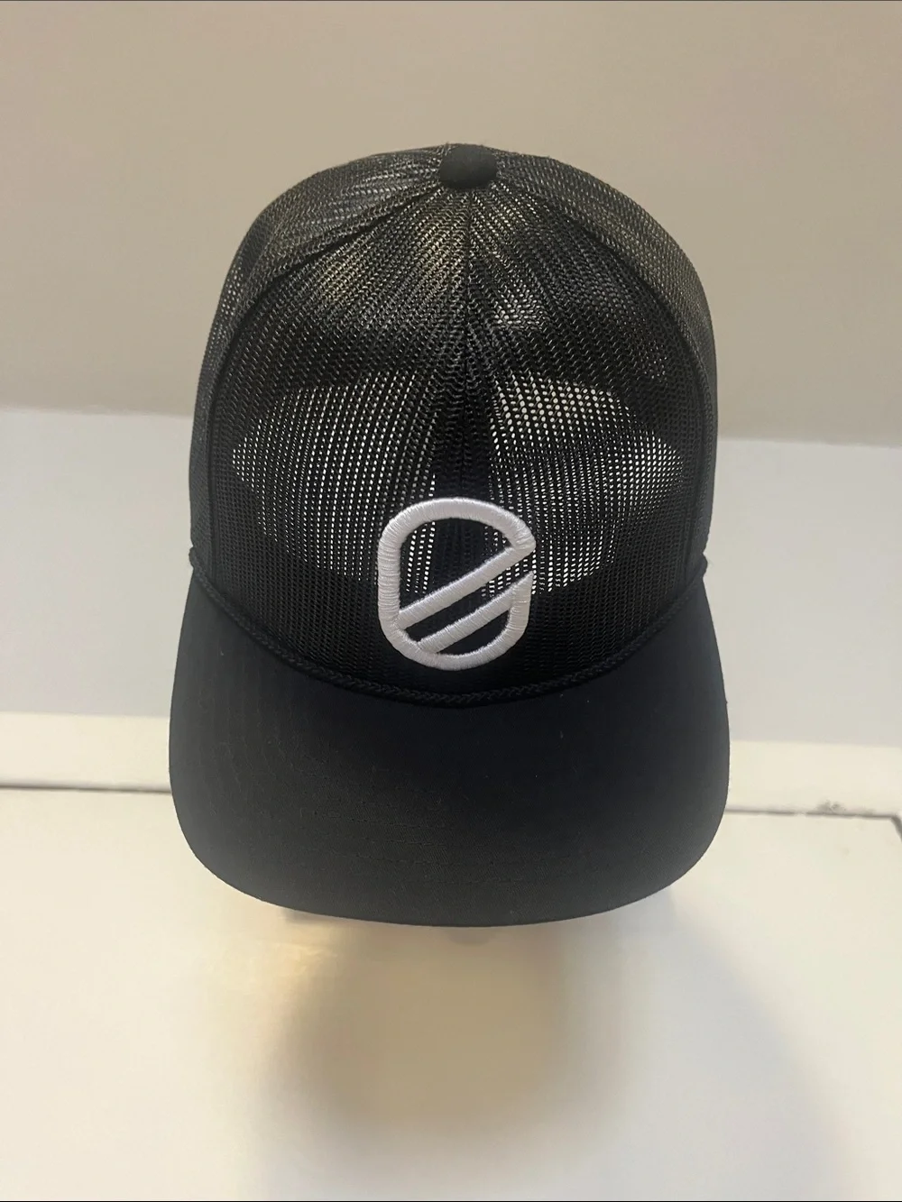Extracurricular Black Mesh Trucker Cap with White Embroidered Logo